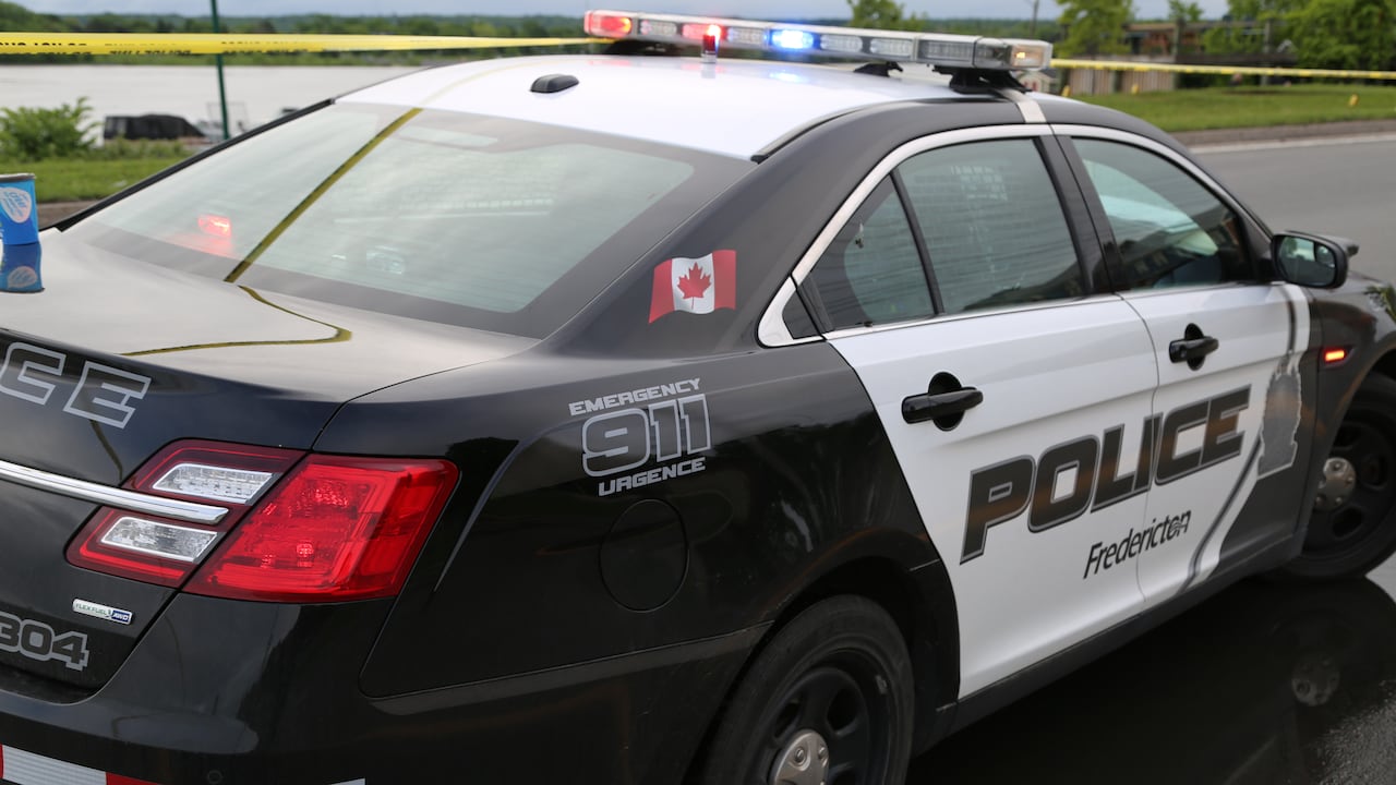 A Fredericton police cruiser parked along a road.