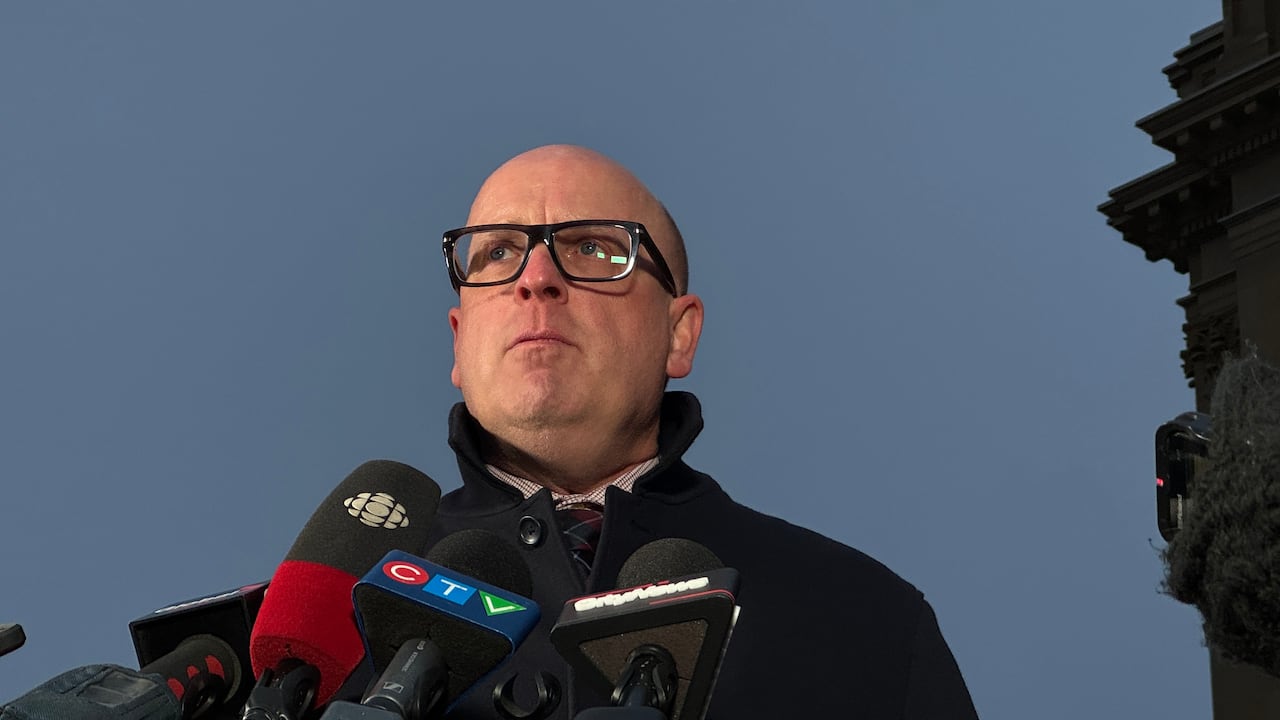 Jason Schilling, president of the Alberta Teachers' Association, stands at a microphone and speaks about the introduction of back to work legislation for teachers.