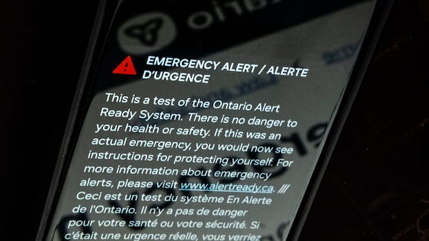 A close up of a smartphone displaying an emergency alert.