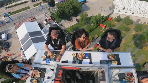 A bird's eye view of four people eating at a table.