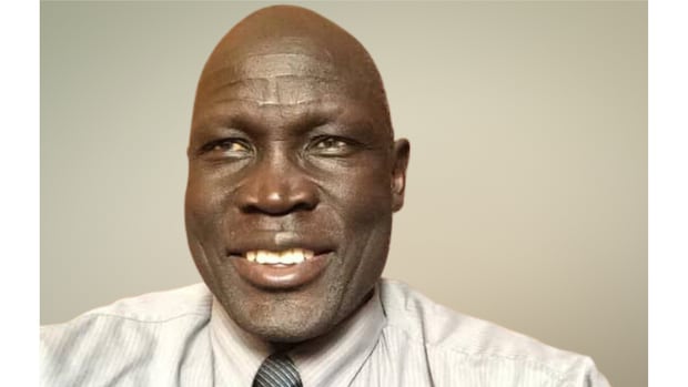 Peter pal Jola was detained after landing in Addis Ababa, ET for importing "military equipment," however the family says the equipment in question was a few sets of walkie-talkies he bought online from Amazon. Image of a man smiling at the camera