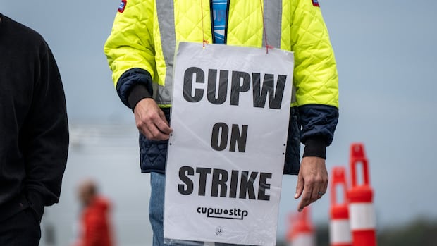 A workers wears a strike sign.