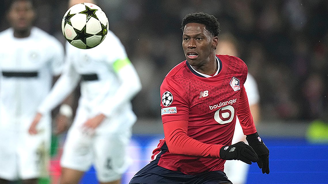 Lille's Jonathan David challenges for the ball with Sturm Graz's Dimitri Lavalee during a Champions League soccer match at the Stade Pierre Mauroy in Villeneuve-d'Ascq, northern France on December 11, 2024.