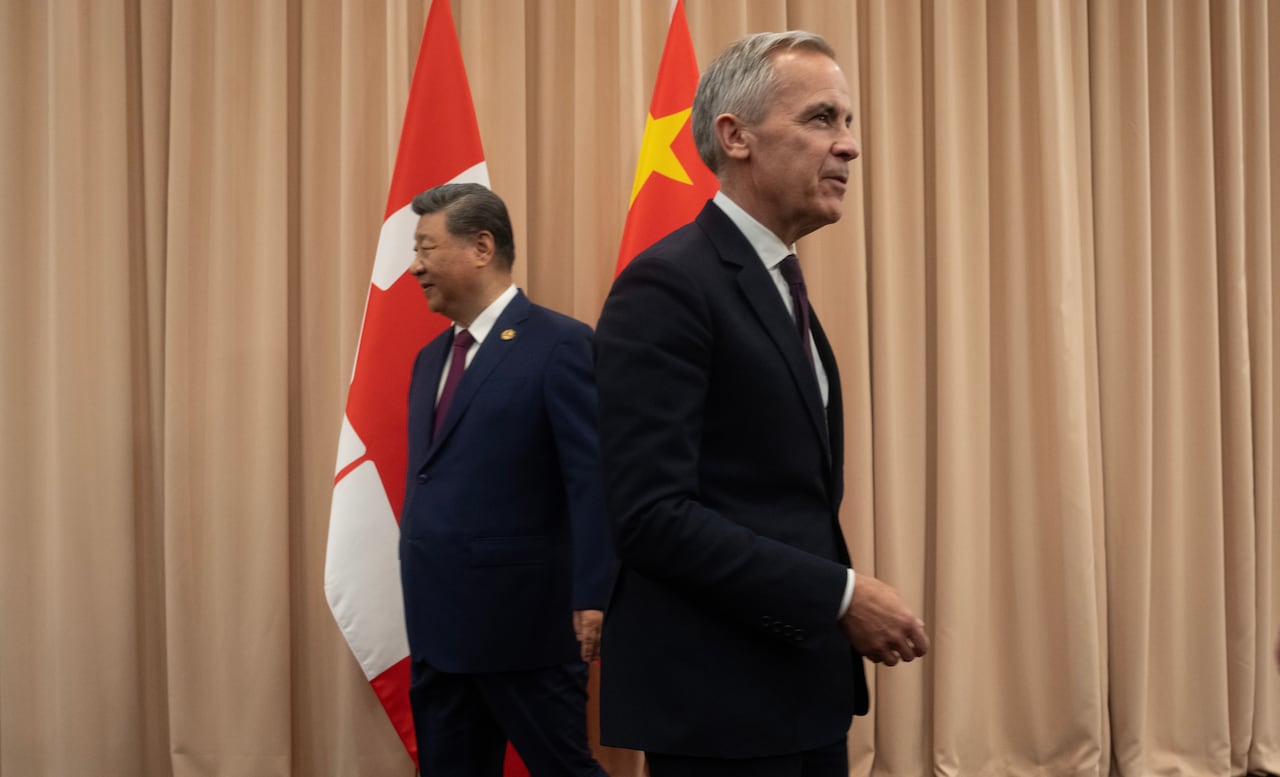 President Xi looks left and Carney looks right