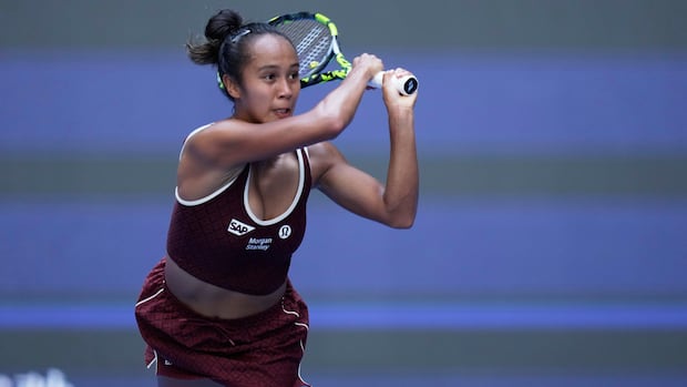 Canada's Leylah Fernandez, pictured at last month's China Open, finished with three aces, seven winners and only four unforced errors and two double faults in Sunday's women's singles final at the Japan Open in Osaka.. A female tennis player holds both hands on the racket after returning a shot.