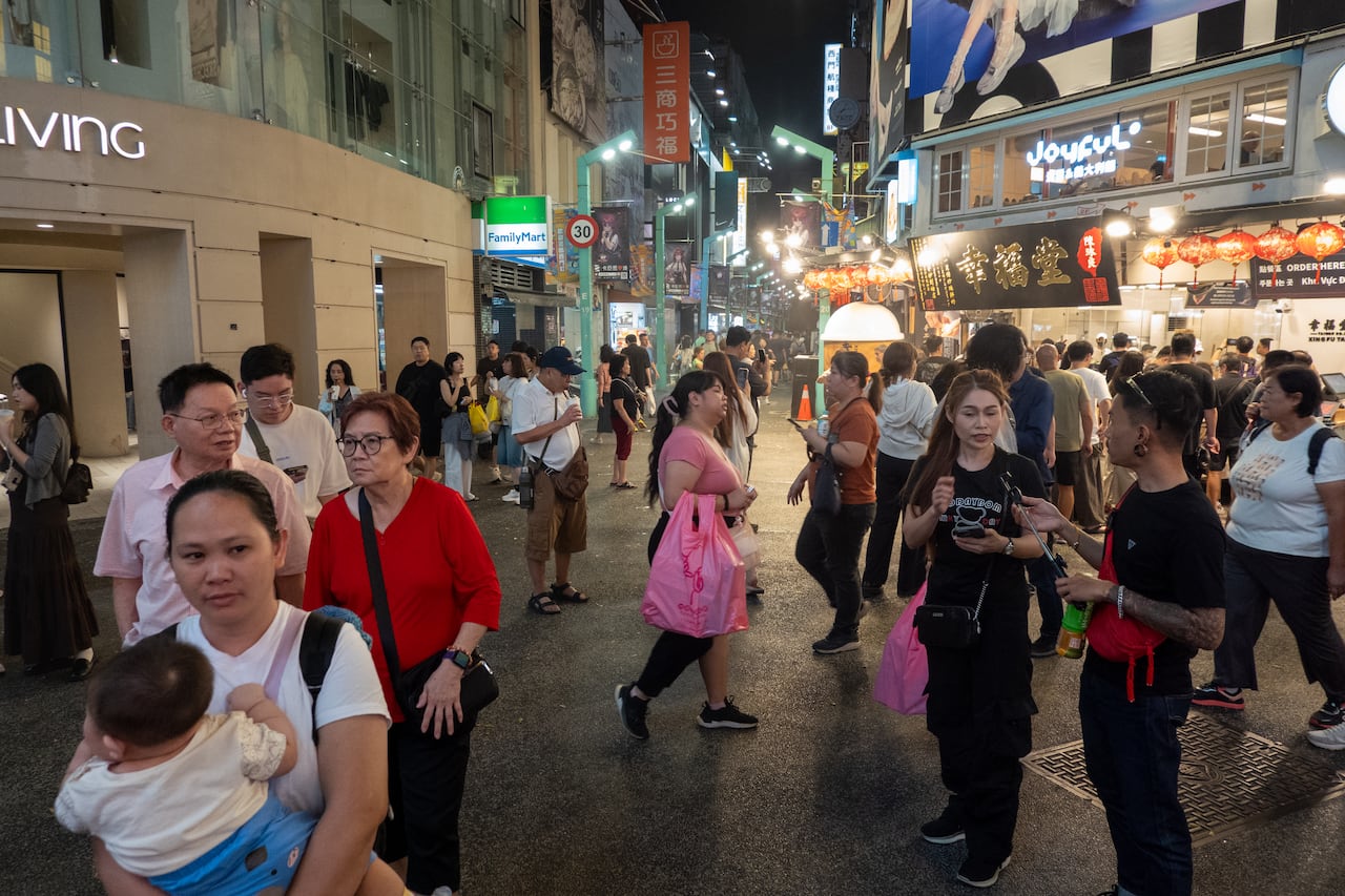 People appear outside the shopping region at night.