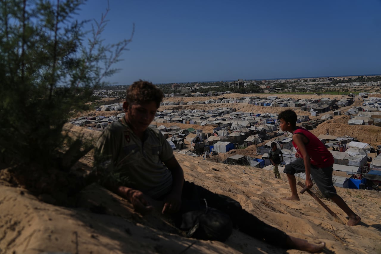 Two children on the hill overlooking the tents