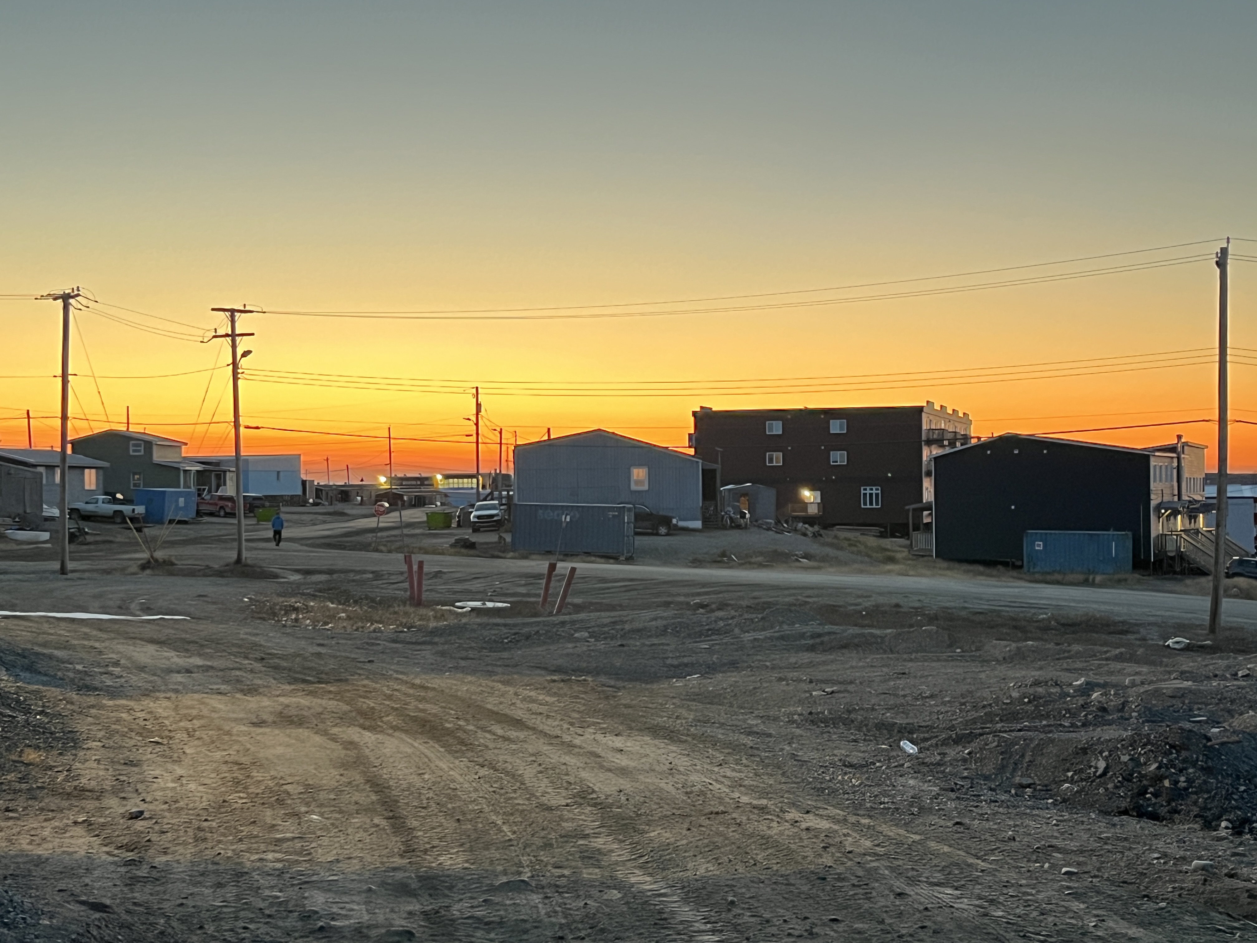 Hydro lines dominate the skyline in Rankin Inlet, Nunavut. The Kivalliq Hydro-Fibre Link would stretch 1,200 km, connecting Manitoba Hydro’s power grid to five western Nunavut communities and a gold mine. It would also offer fibre-optic connectivity, delivering high-speed internet service. The sun sets over Rankin Inlet, Nunavut