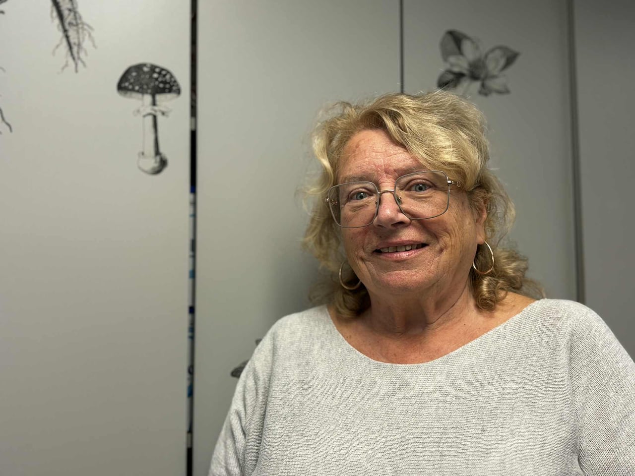 A woman smiles at the camera