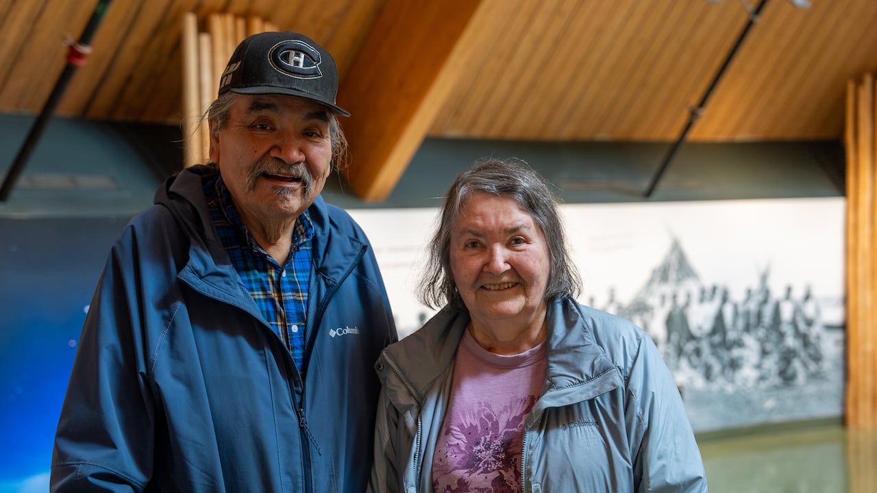 Man and woman stand inside building