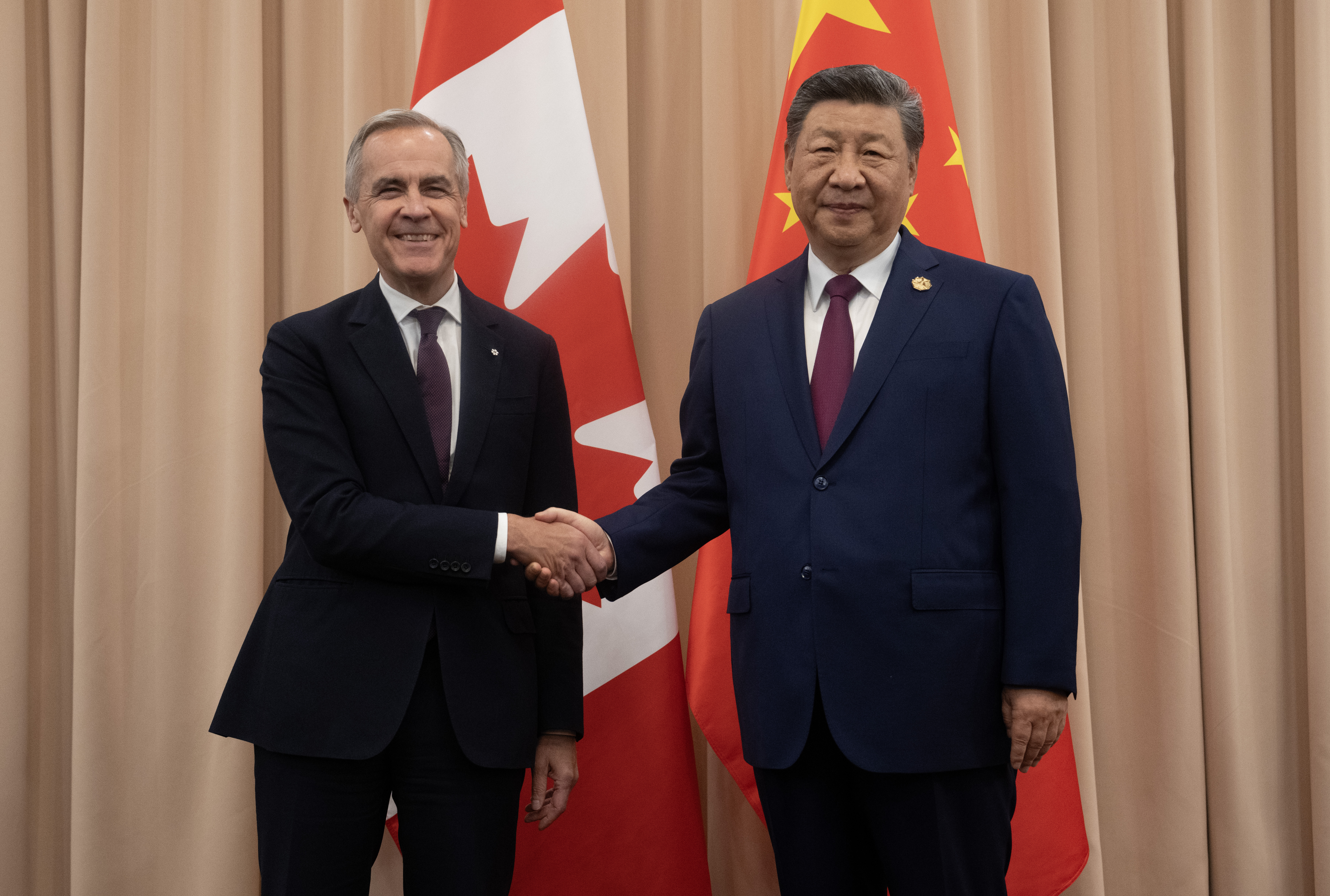 Carney and Xi agree to tackle 'irritants' in Canada-China relationship; Prime Minister Mark Carney shakes hands with Chinese President Xi Jinping at the start of a meeting in Gyeongju, Friday\. The two leaders spoke for almost 40 minutes\.