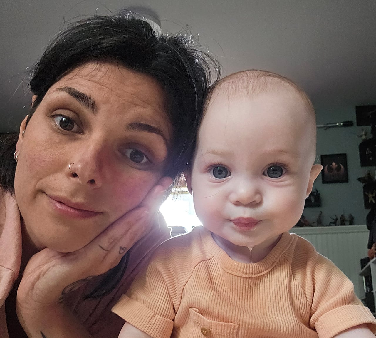 A woman and baby look at the camera.