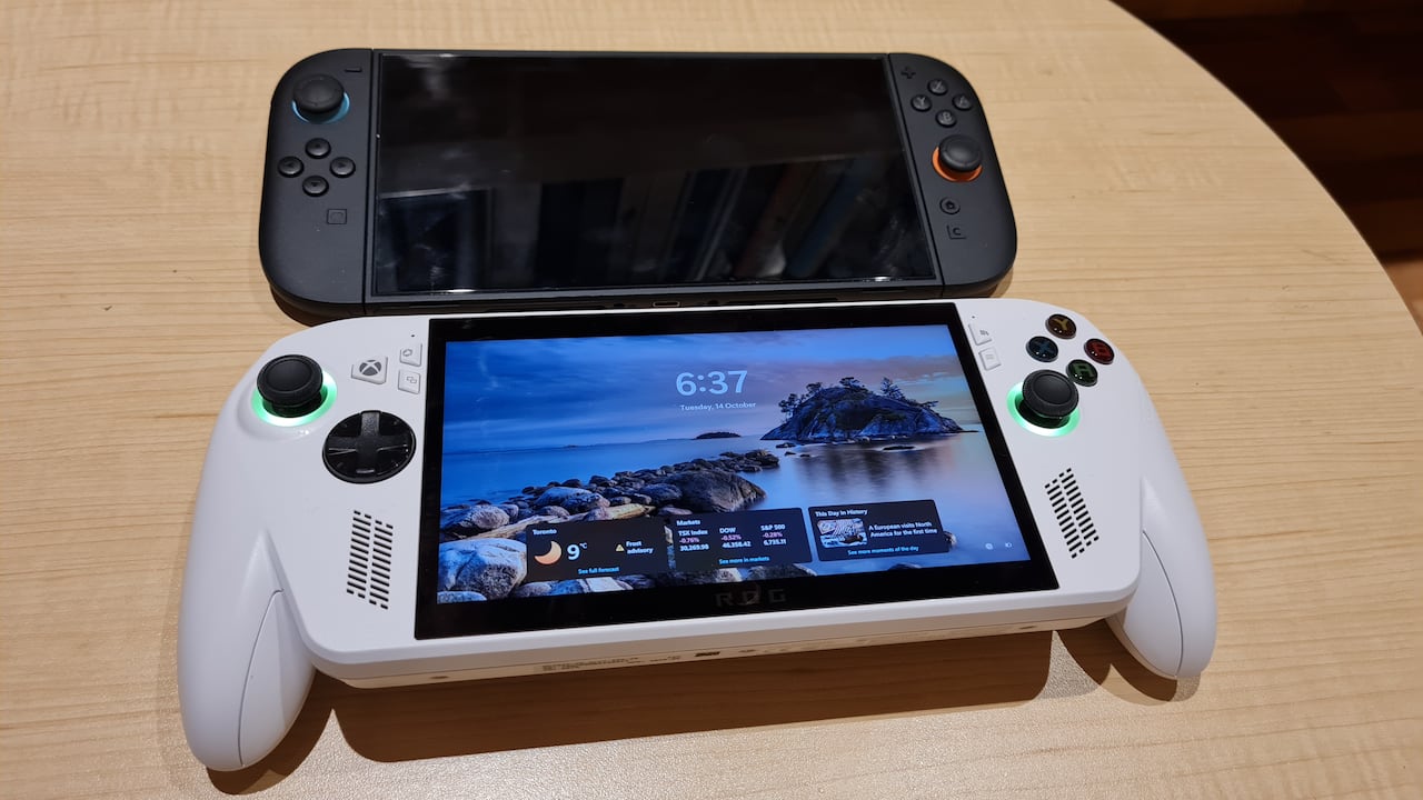 Two gaming handheld devices are seen on a table.
