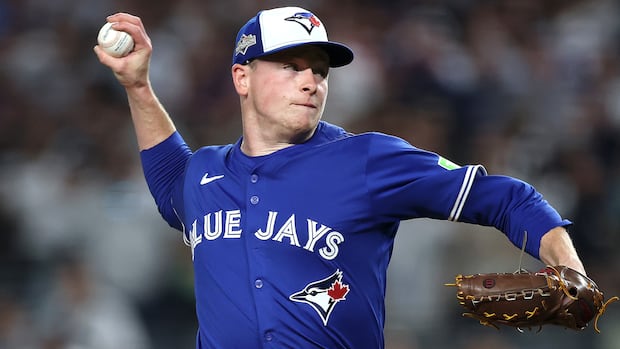 NEW YORK, NEW YORK - OCTOBER 07: Louis Varland #77 of the Toronto Blue Jays pitches against the New York Yankees during the fifth inning in game three of the American League Division Series at Yankee Stadium on October 07, 2025 in the Bronx borough of New York City. (Photo by Ishika Samant/Getty Images) A man throwing a baseball.