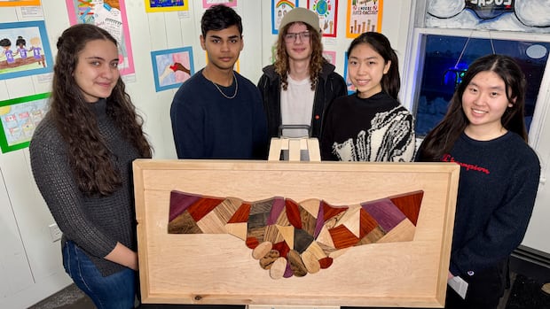 From left: Emili Mayaleh, Sarvessh Dhanasekar, Jacob McGee, Kate Shi and Wincy Chan. These Grade 12 students at Colonel Gray High School in Charlottetown organized an anti-racism art exhibit. Five Grade 12 students are shown holding a piece of artwork.