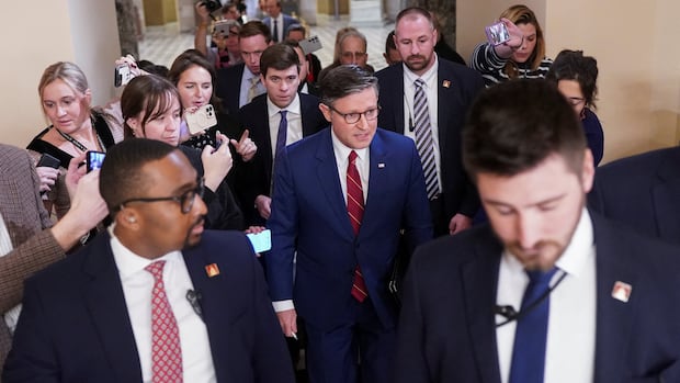 U.S. Speaker of the House Mike Johnson (R-LA) walks surrounded by the media, as members of the U.S. House of Representatives returned to Washington after a 53-day break, for a vote that could bring the longest U.S. government shutdown in history to a close, on Capitol Hill in Washington, D.C., U.S., November 12, 2025. REUTERS/Nathan Howard A group of reporters, crowding around a politician