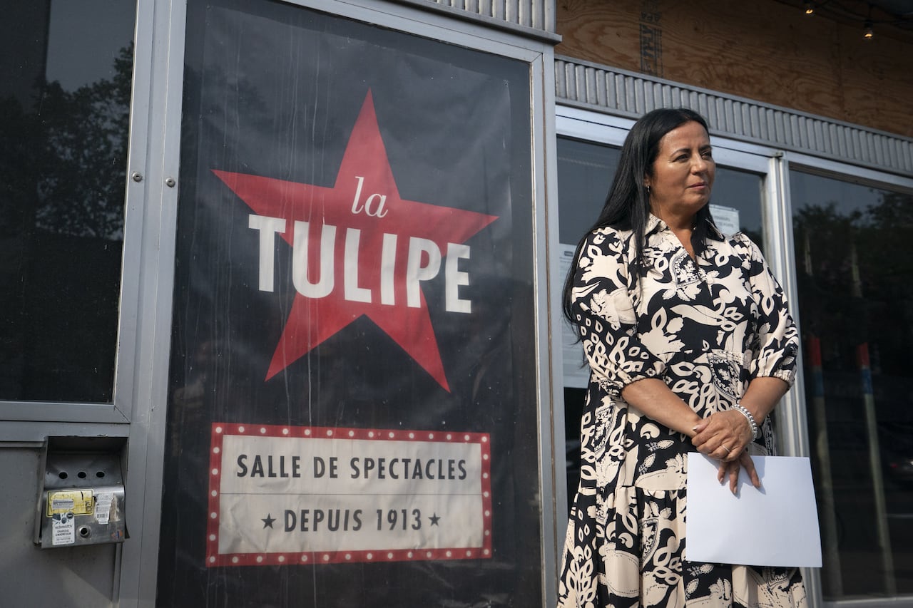 Woman standing in front of the La Tulipe sign