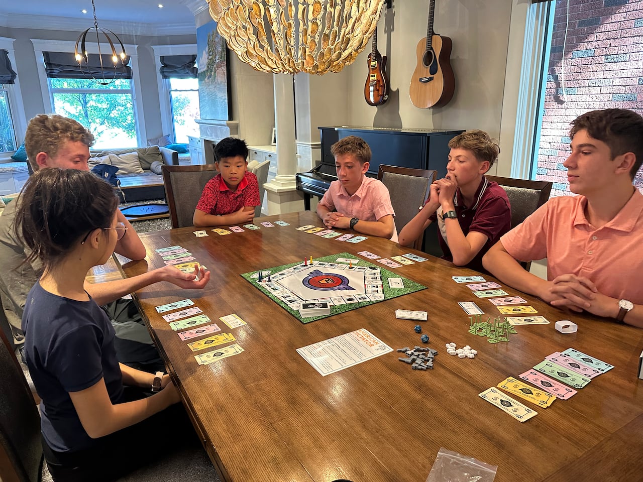 A group of teens play a board game