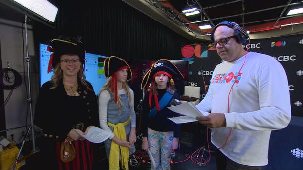 Students and their principal stand with Min Dhariwal at the CBC centre stage