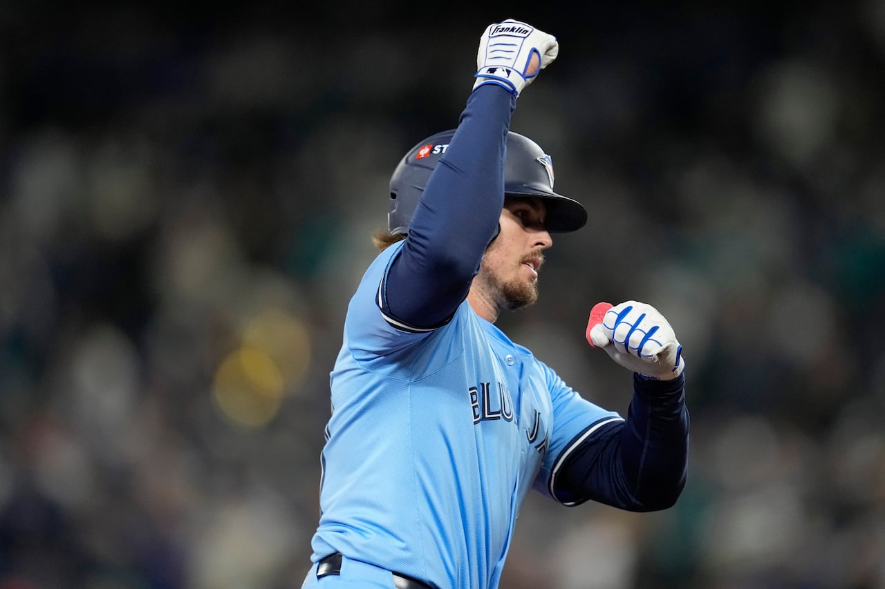 A baseball player pumps his fist, after hitting a home run