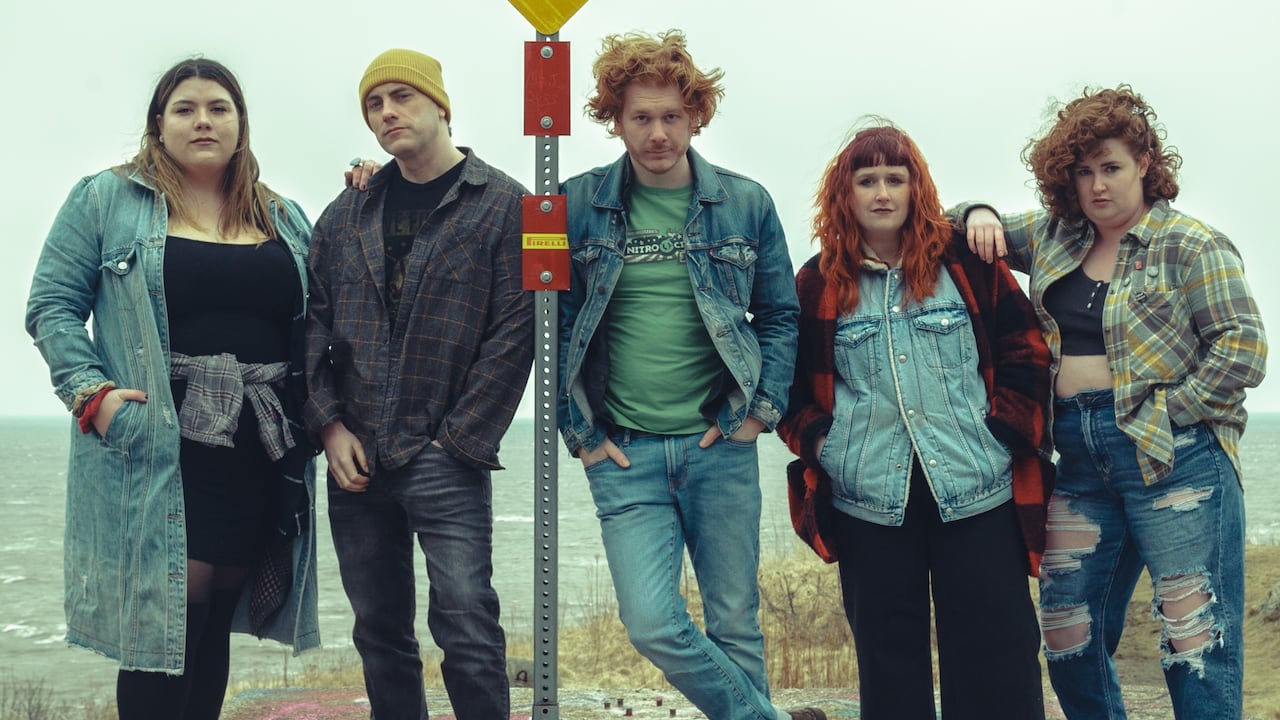 Five radical   basal   adjacent  to a achromatic  and yellowish  checkerboard roadworthy  motion   adjacent  to a assemblage  of h2o  with choppy waves. 