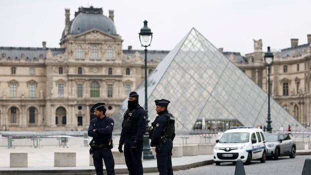Police stand guard outside a meseum.