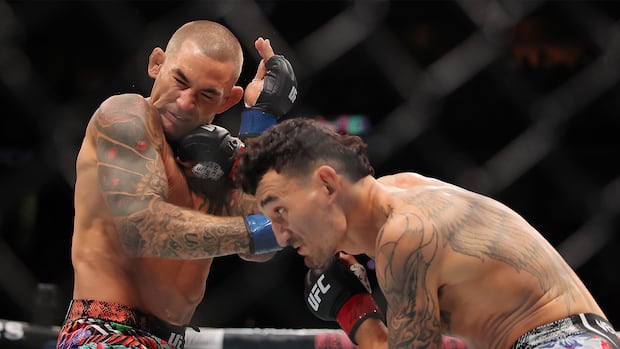 Two men are fighting in a ring. 