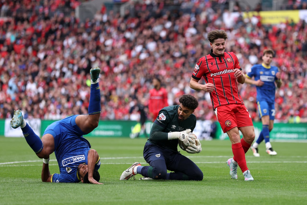 A soccer goalie makes a save.