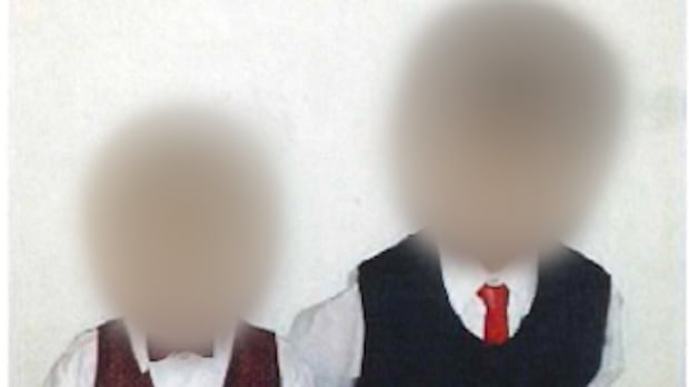 J.L. and L.L., left to right, are shown in an undated photo filed as a court exhibit. Their Burlington, Ont., teachers described them as clever, curious and eager students. Two boys in suits
