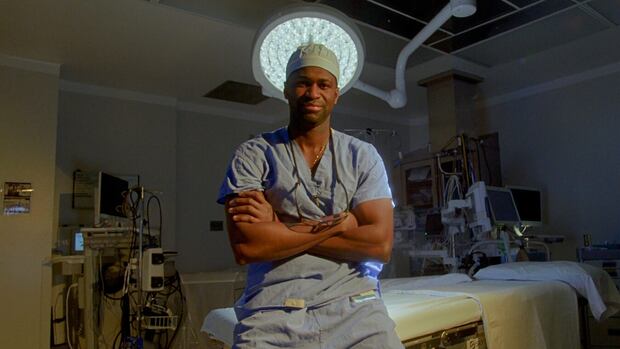 Doctor leans on operating table