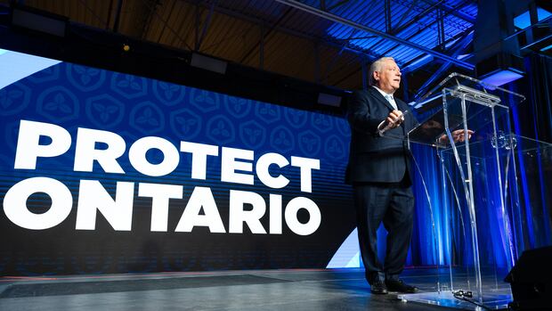 Newly re-elected Ontario Premier Doug Ford speaks to supporters at his election night event in Toronto on Thursday, February 27, 2025. THE CANADIAN PRESS/Laura Proctor A man standing behind a podium. Behind him, there is a large screen that reads: "Protect Ontario."