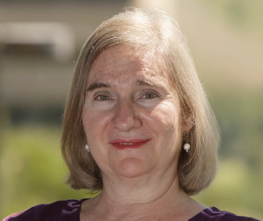 A blonde pistillate   with a bob smiling astatine  the camera successful  a headshot