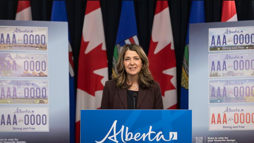 A woman poses on a podium.
