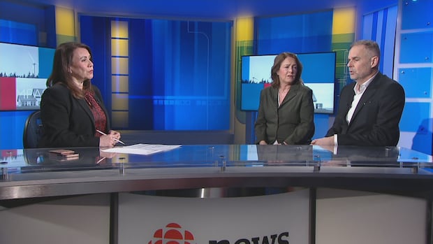 Louise Martin with the two members of CBC Prince Edward Island's political panel: Sally Pitt and Paul MacNeill. A woman in a business jacket at a TV anchor desk talks to a man and woman also in business clothes.