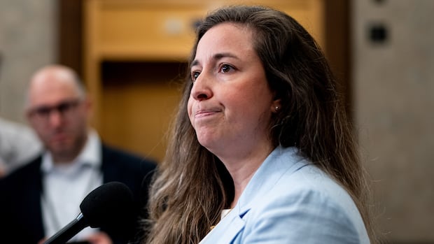 A woman speaks into a microphone.