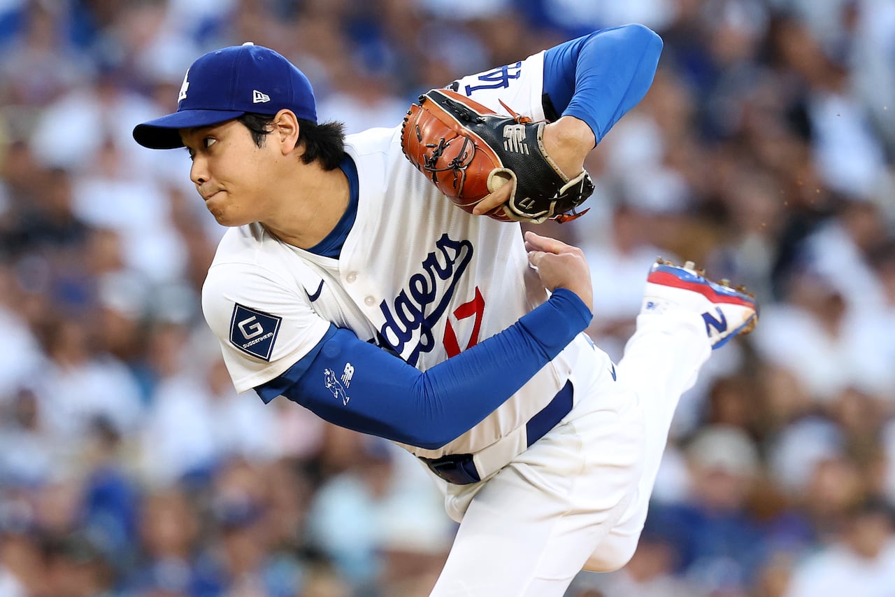 A baseball pitcher in the follow-through of his windup
