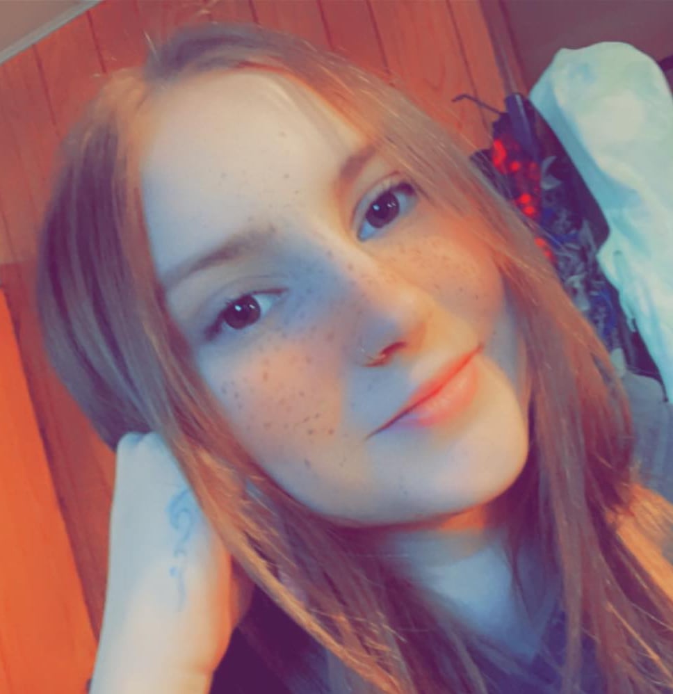 A young red headed woman in a selfie photo