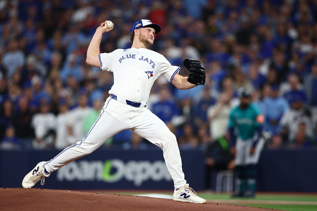 A man in a baseball uniform throws a pitch