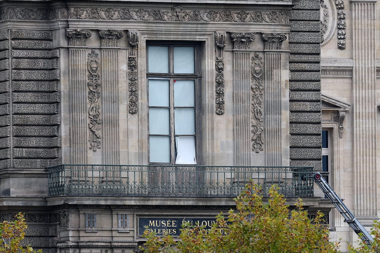A window pane is seen removed from an ornate window.