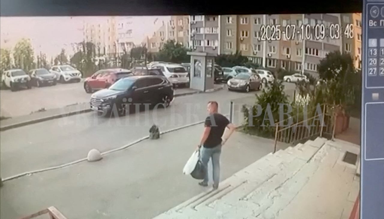 CCTV footage of a man descending a flight of stairs outside the building.