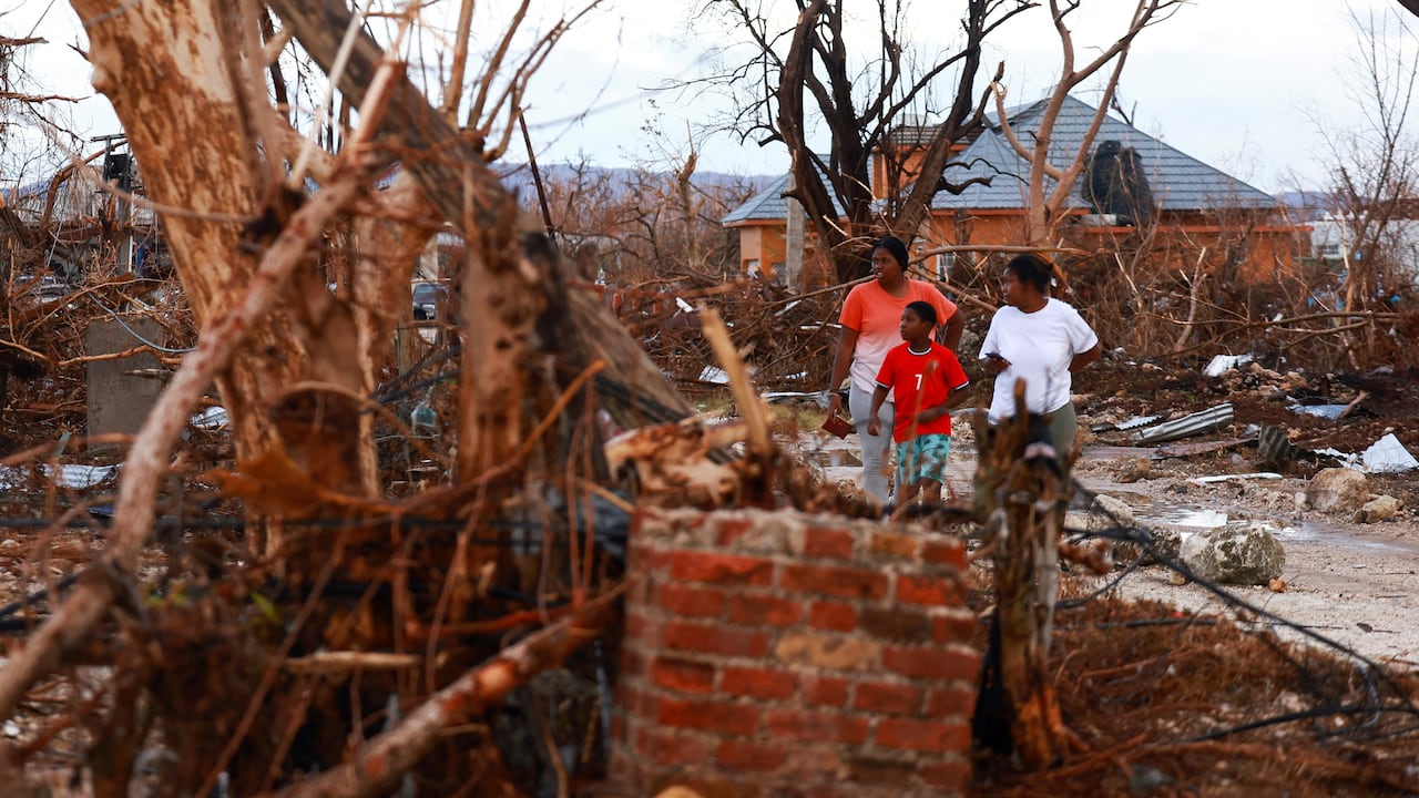 People standing amid wreckage