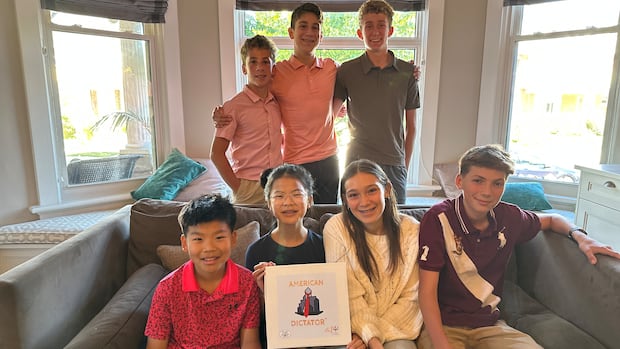 William Palma 13, Adam Palma 15, Ben Whitmill 15, Johnathan Ip, 11, Lauren Ip, 13, Kiara Palma, 17, Wenzel Steinbock 14, left to right, are from London, Ont., are the creators of the new board game American Dictator. A group of teens hold a board game.