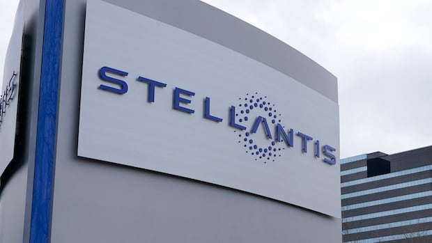 A grey sign on a building that says "Stellantis."