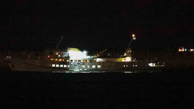 A vessel from the Freedom Flotilla Coalition (FFC) seeking to deliver aid to Gaza, is escorted by Israeli vessels to Ashdod Port in southern Israel, October 8, 2025. REUTERS/Ammar Awad A view of a boat, taken at nighttime