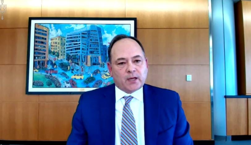 A man wearing a blue suit and striped tie.