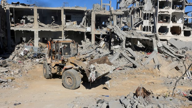 Heavy machinery removes debris from a street, amid a ceasefire between Israel and Hamas, in Gaza City, October 14, 2025. REUTERS/Dawoud Abu Alkas Heavy machinery removes debris from a street.