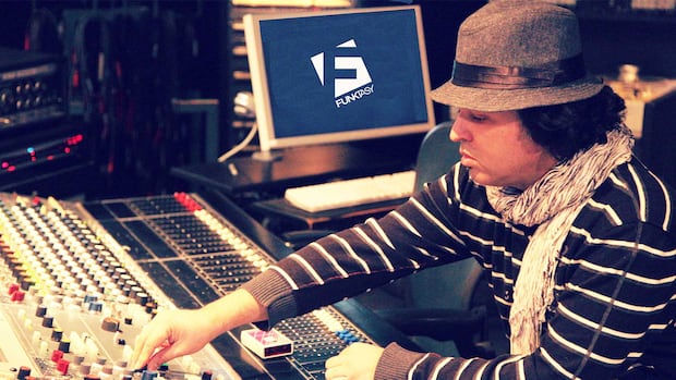 A man at a mixing board.