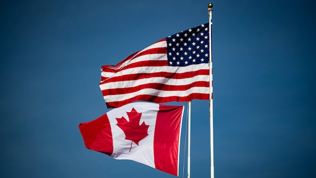 Canadian and U.S. flags fly atop the Peace Arch monument at the Douglas-Peace Arch border crossing in Surrey, B.C., on Monday, November 8, 2021. Fully vaccinated Canadians were once again paying long-awaited visits to loved ones, vacation properties and tourist destinations in the United States on Monday as southbound travel restrictions finally began to ease along the world's longest unmilitarized land border. THE CANADIAN PRESS/Darryl Dyck Canadian and U.S. flags wave in the wind.