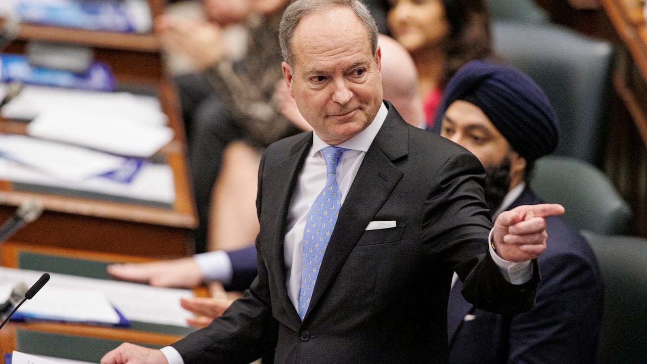 Man points astatine  a person.