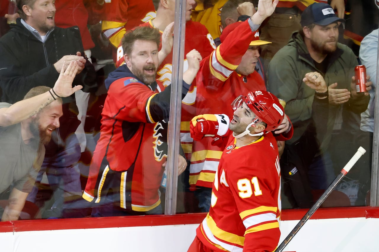Calgary Flames centre Nazem Kadri and fans celebrating.